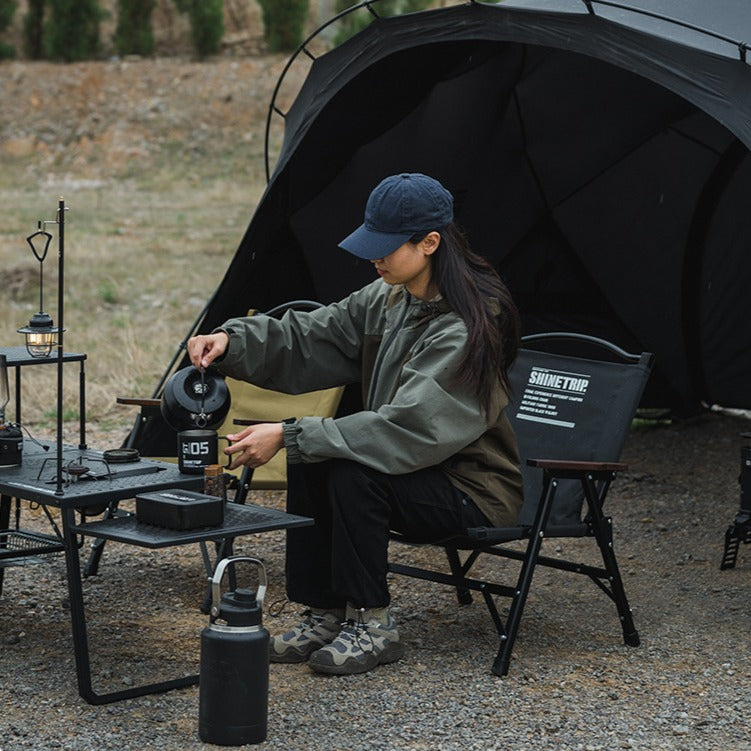 ShineTrip compact folding camping chair used around a campsite while preparing coffee, lightweight folding chair for camping in British Columbia.