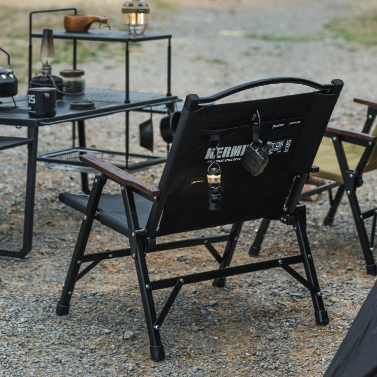 Rear view of the ShineTrip compact folding camping chair highlighting the storage pocket and tactical outdoor design.