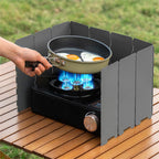 Campstone camping stove windbreak blocking wind to stabilize flame during outdoor cooking
