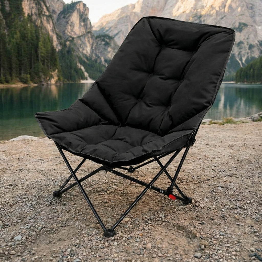 Comfortable padded camping chair placed outdoors near a mountain lake for relaxed seating