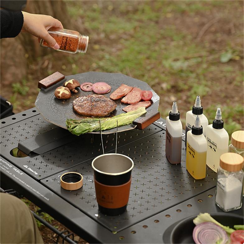 camping bbq cooking with seasoning bottles and spice kit