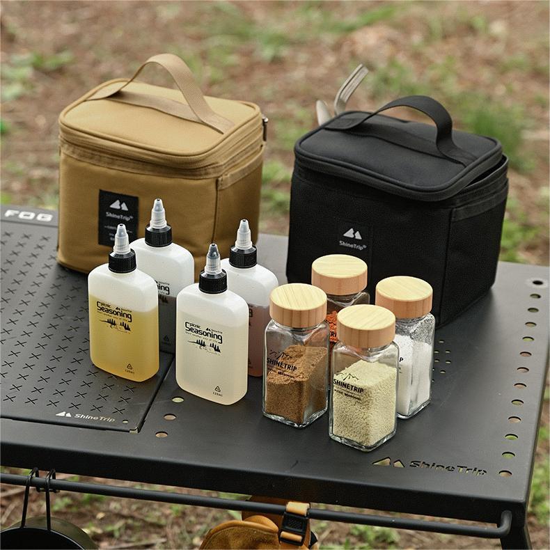 camping spice bottles set flat lay with glass jars and liquid bottles